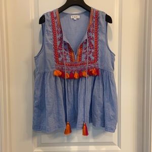 Lightweight peplum top with tassels